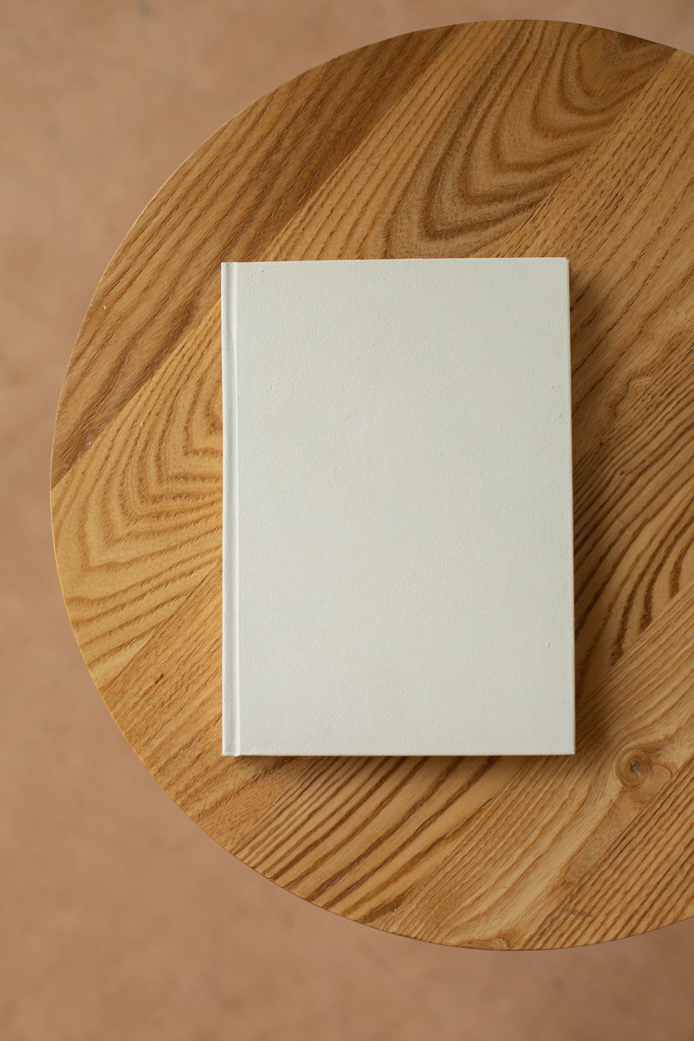Plain white notebook on a wooden table