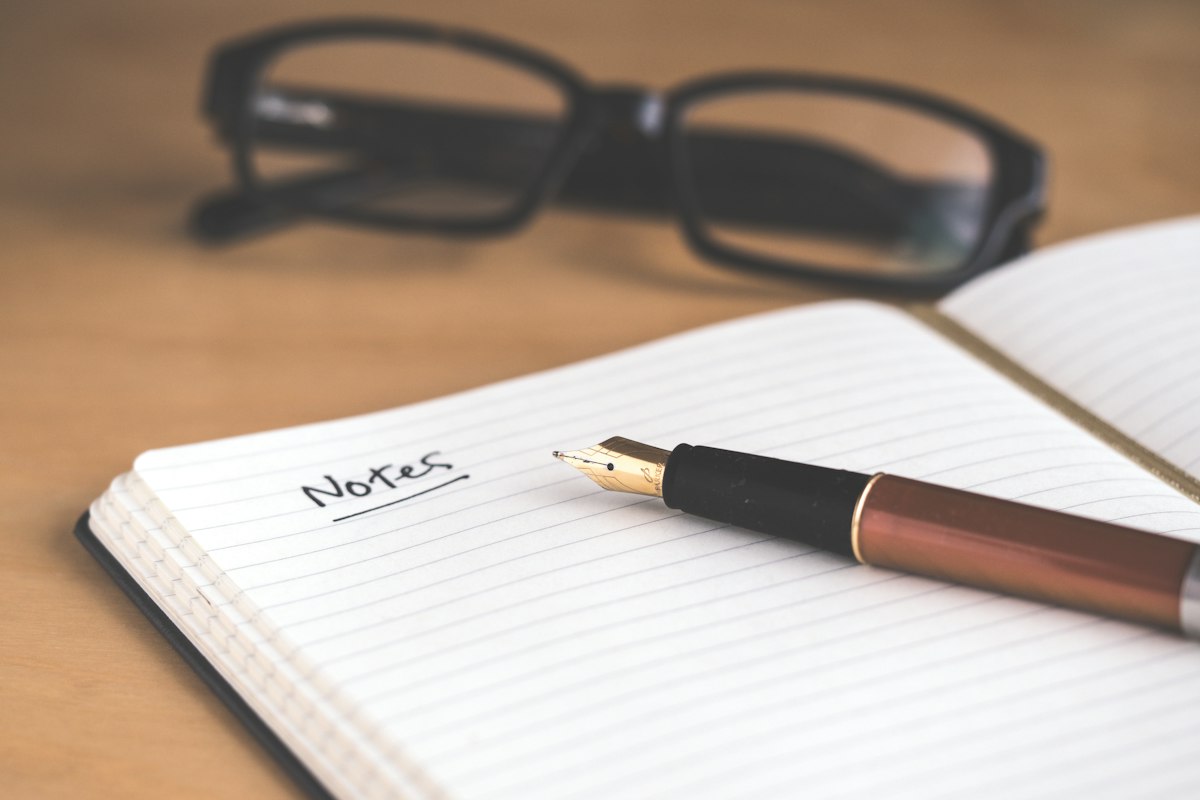 Open notebook with a fountain pen on a desk